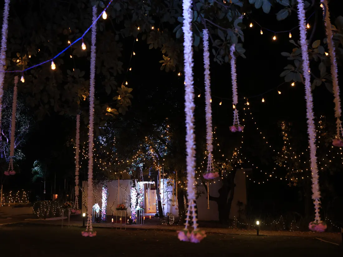 The lawn at Nehamrit Farms under hanging lights and floral drapes for a wedding
